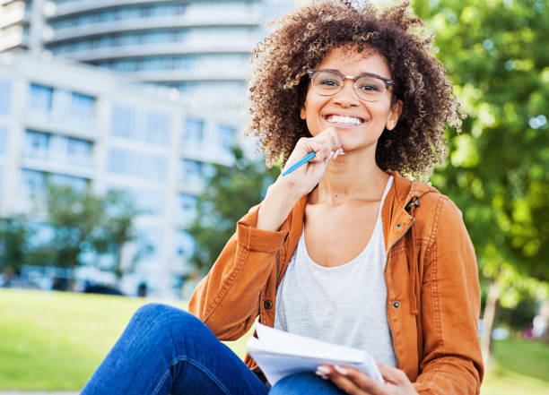 Female University Student  Writing in Notebook